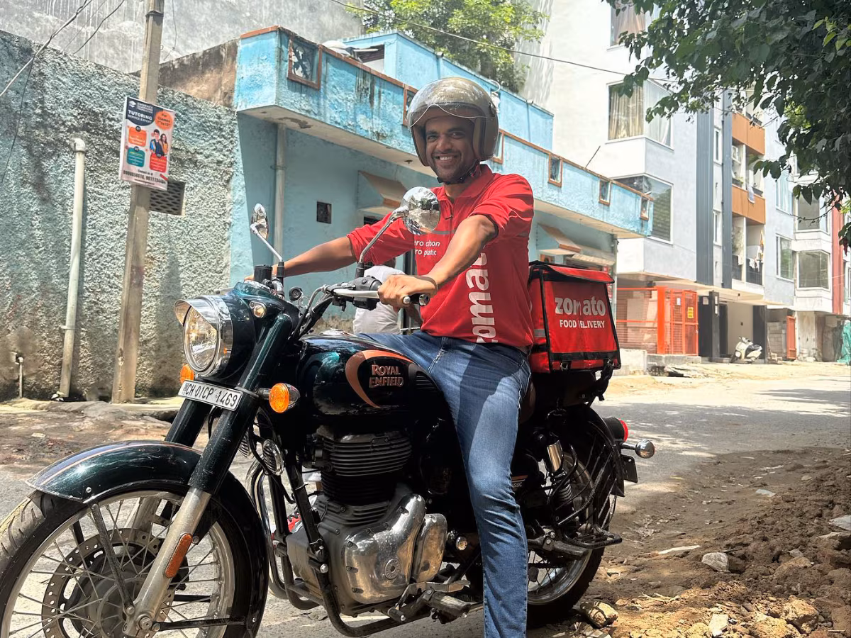 Deepinder Goyal, founder of Zomato, delivering food on a Royal Enfield in India.